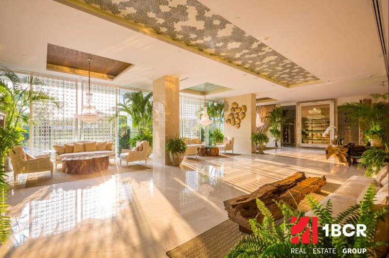Luxury interior hall with stylish accessories and plants in apartment construction.