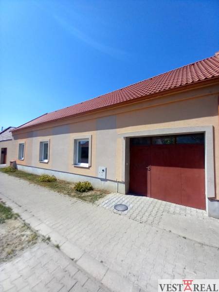 A family house in Trakovice with a sloped roof and two windows facing the street.