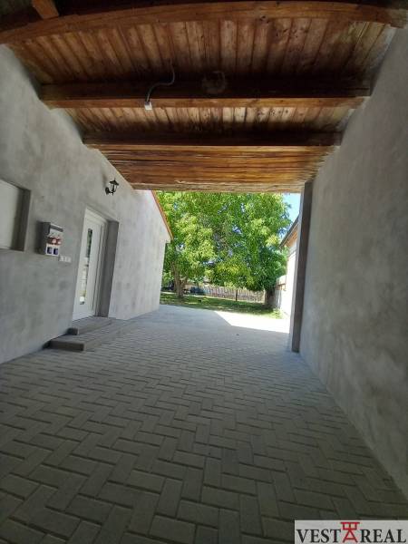 The passage between the buildings of a family house in Trakovice, a paved area leading to the yard.