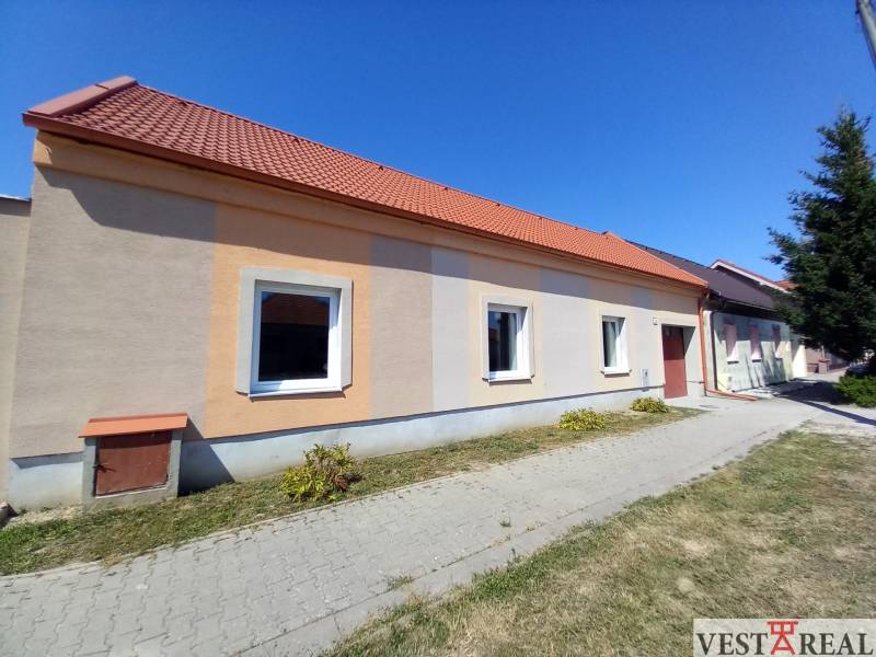 A family house in Trakovice with an orange facade and a red roof.
