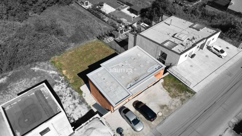 Aerial view of a family house in Trnové near Žilina with parked cars.