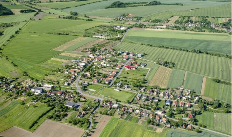 Aerial view of the village between fields in Kamenné Kosihy, ideal for commercial land.