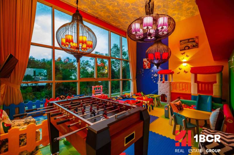 Children's playroom with a football table and indoor games in apartment construction.