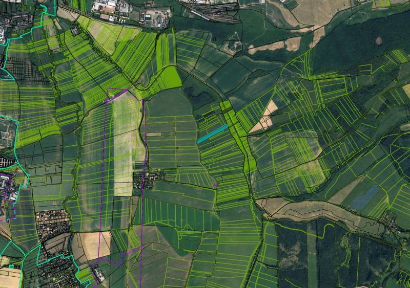 Aerial view of agricultural and forest lands around Sučany, various fields and green zones.