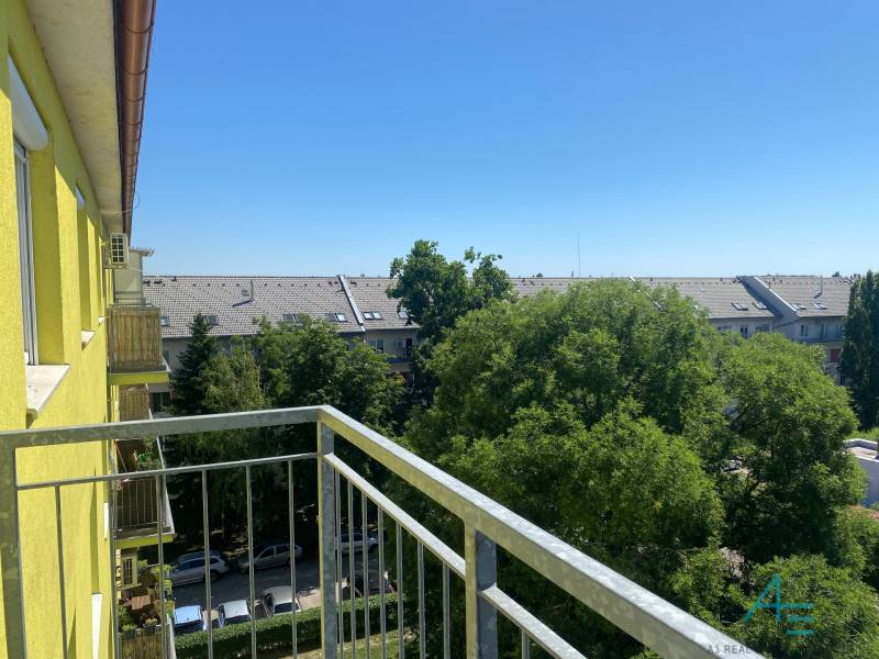 View from the balcony of a 3-room apartment on Na úvrati street in Bratislava, tree greenery.