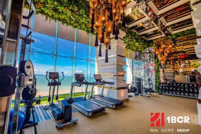 Luxury gym with a beach view within the apartment development.