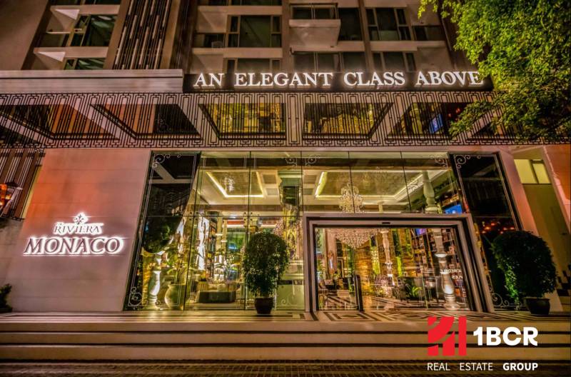 Entrance to the Apartment Complex with a lit sign in Pattaya, luxuriously furnished interior.
