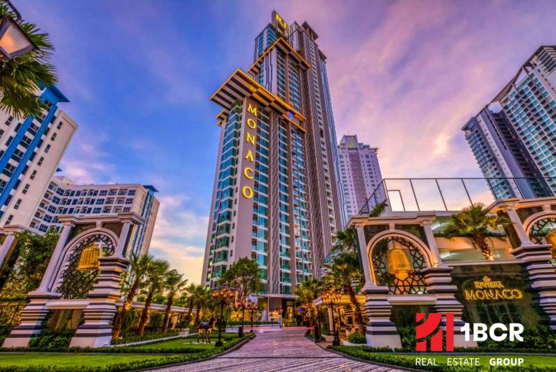 The Monaco skyscraper in the center of residential development in the city of Pattaya, surrounded by palm trees.