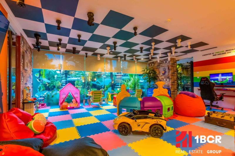 Colorful children's playroom with toys and play area. Apartment construction.