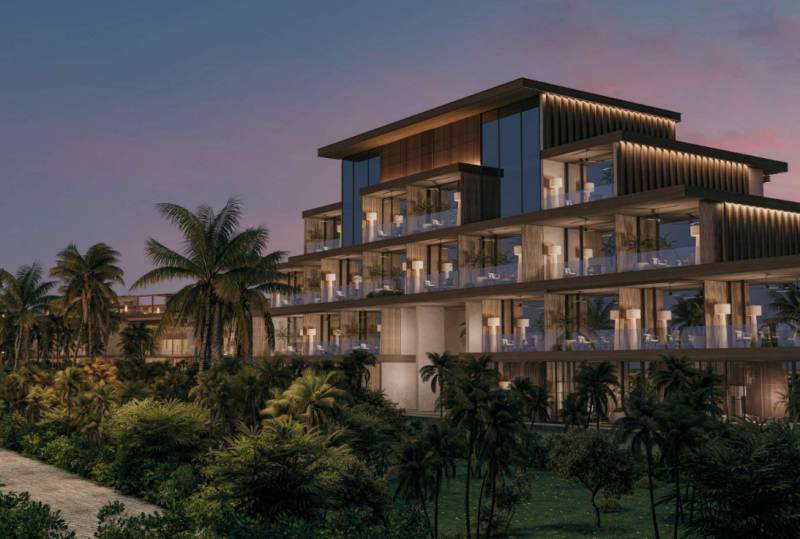 A view of a multi-story family house with palm trees on Nungwi Street in Zanzibar North.