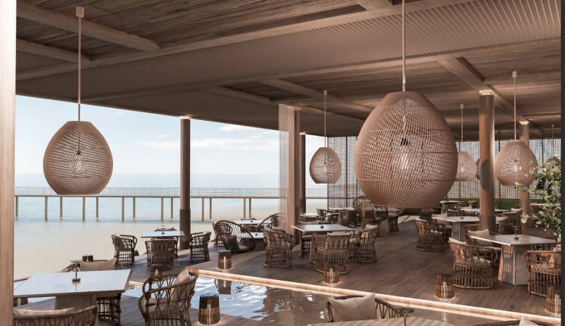 Luxury restaurant with ocean view, stylish pendant lights, comfortable seating.