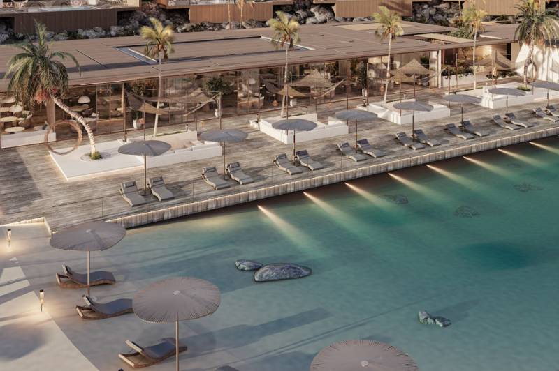 Luxury pool and beach loungers in front of a family house on the coast.