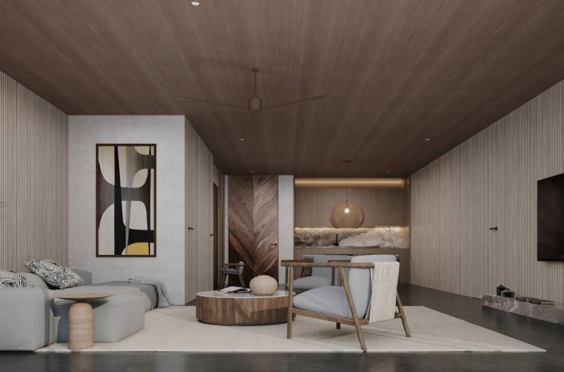 Interior of a family house with a sofa, armchairs, and artwork on the wall.