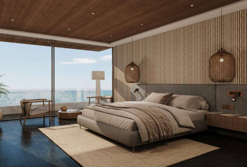 A bedroom in a family house with large windows, a wooden ceiling, and elegant furniture.