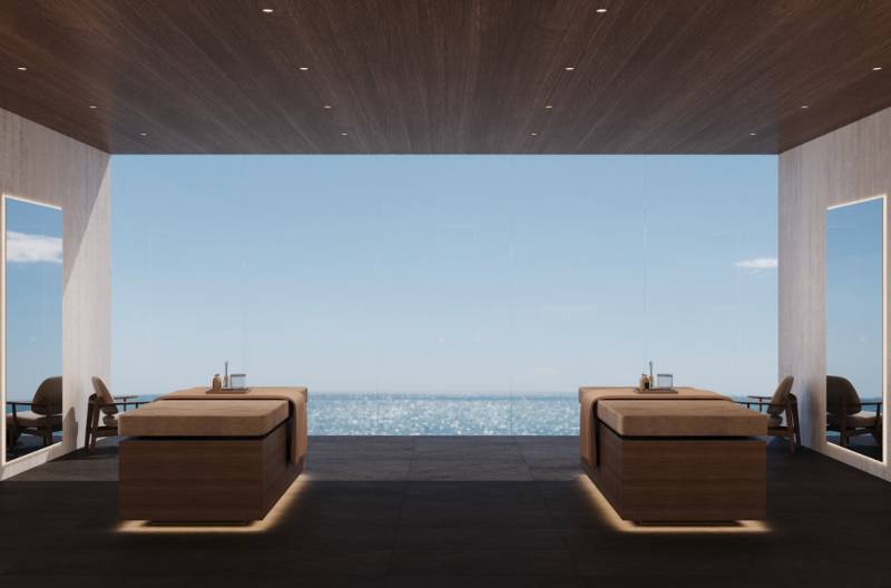 Interior with ocean view, two massage tables, and the sign 