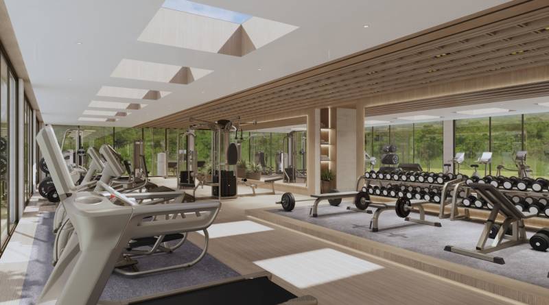 A gym in a family house equipped with treadmills, dumbbells, and cardio equipment.