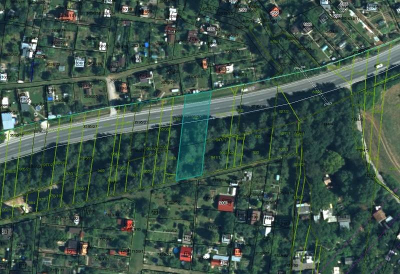Satellite image of agricultural and forest lands in Prievidza with prominent parcel lines.