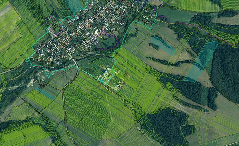 Ladomirová with agricultural and forest lands, showing the village and surrounding fields.