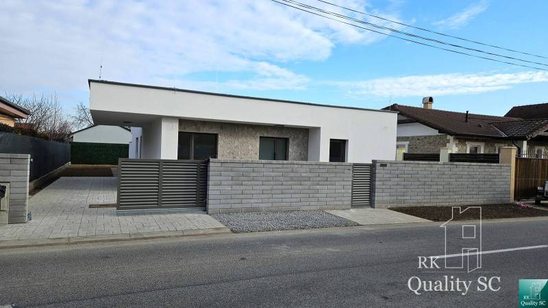 A family house in the village of Tureň with modern architecture and a stone facade.