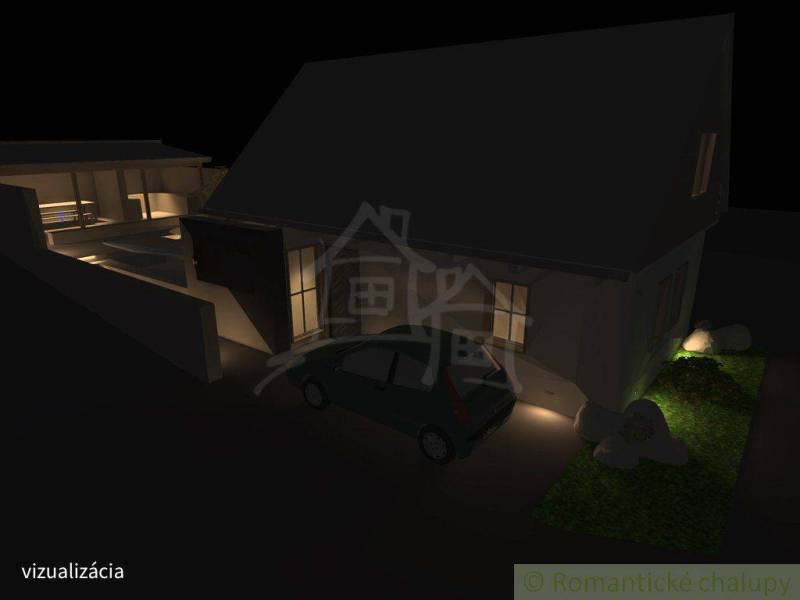 A night view of a family house in Banská Bystrica with illuminated exterior.