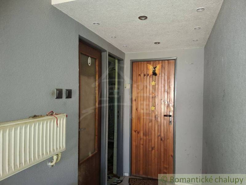 Entrance hallway in a family house with wooden doors and a radiator.