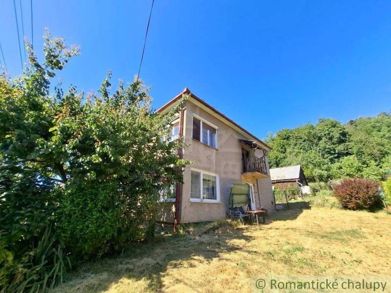 A family house in Lovinobaňa with a large garden and a wooden gazebo in the background.