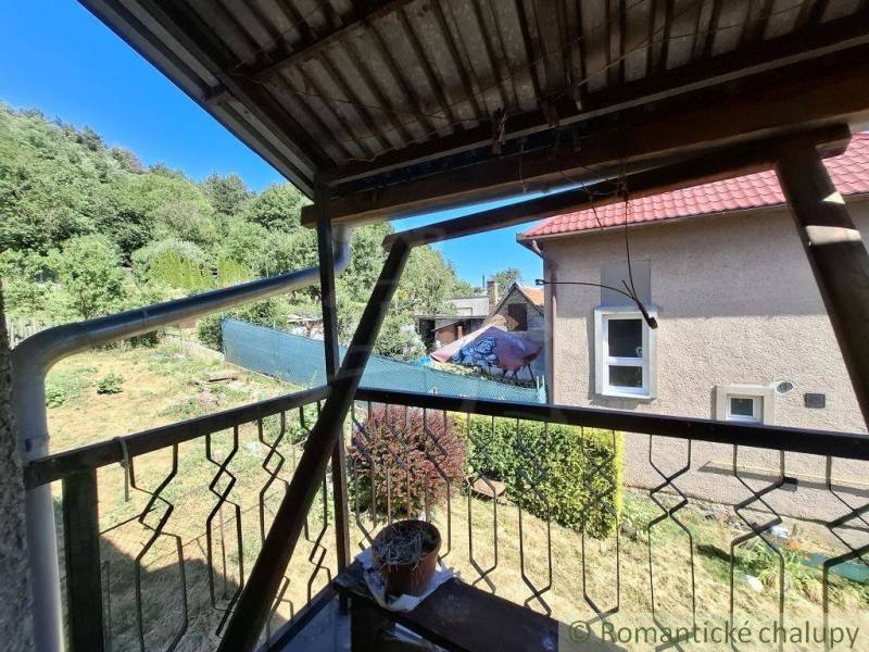 A family house in Lovinobaňa with a terrace, overlooking the garden and surrounding trees.