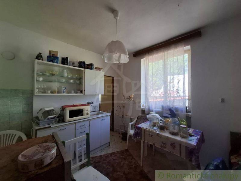 Traditional kitchen with furniture and dining area in a family house.