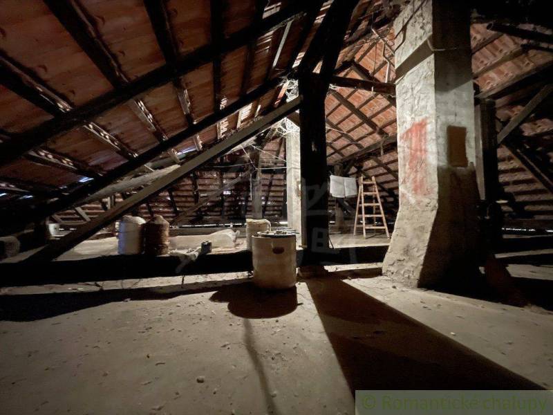 Attic space of a family house with a beam ceiling and reinforced columns.