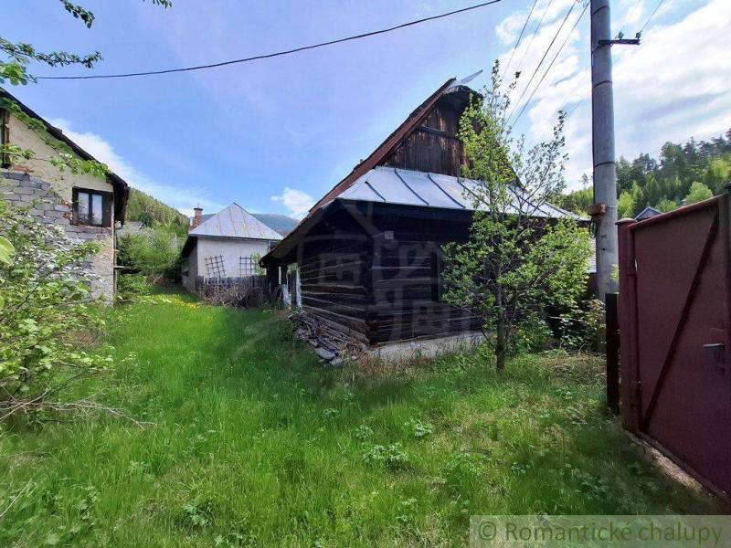 A family house in Pohorelá with traditional wooden construction and greenery in the surroundings.