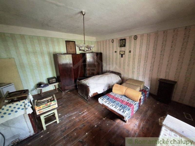 A retro room in a family house with two beds and a wooden floor.