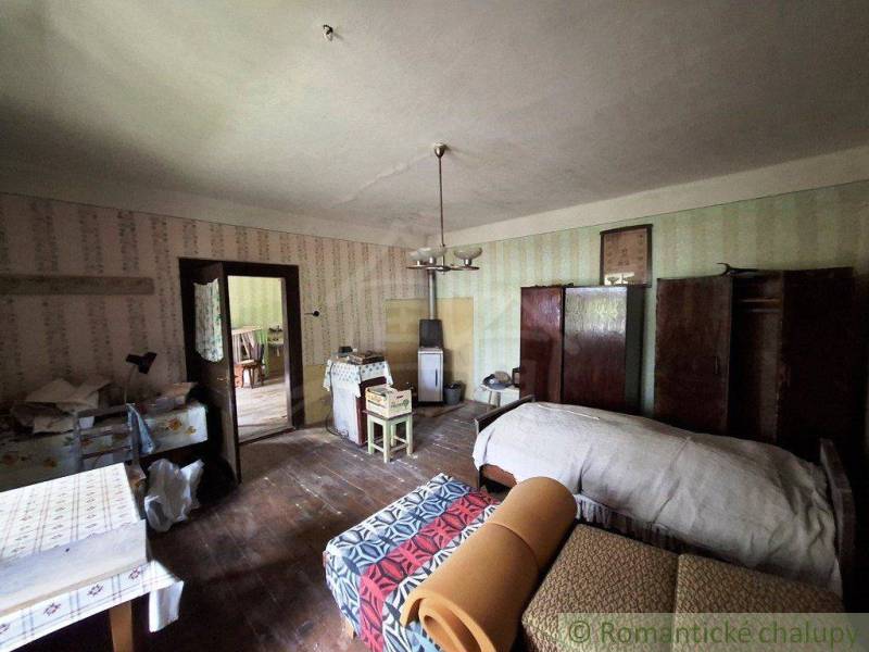 A room in a family house with a bed, furniture, and classic decorations.