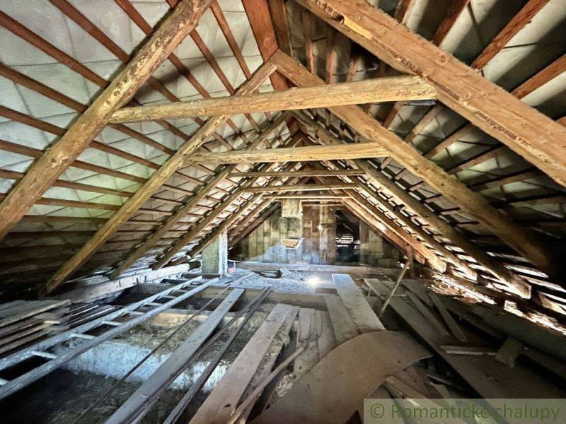 The attic of a family house full of wooden beams and building materials.