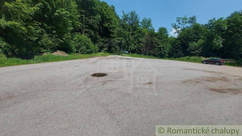 Asphalt area surrounded by forest in Stará Myjava, suitable for commercial spaces.