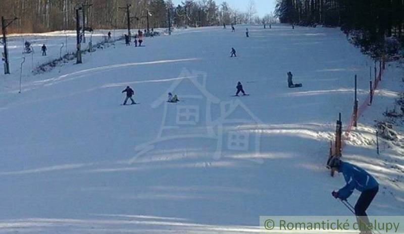 Skiers on the snowy slope in Stará Myjava with awarded slopes.