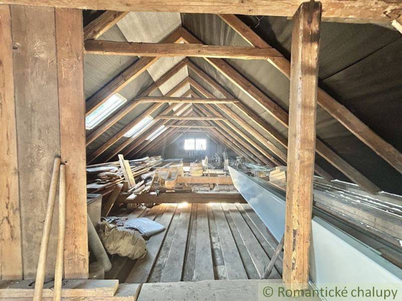 The attic of a family house with an old wooden frame and storage space.