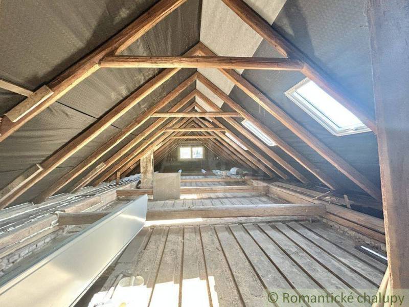 The attic of a family house with wooden beams and roof windows in Spišská Nová Ves.