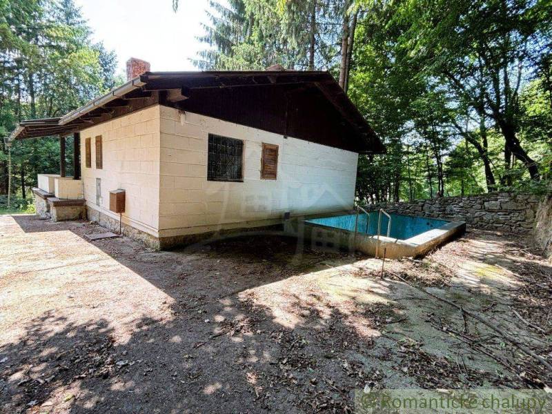 A family house in Malacky surrounded by forest with a pool and a terrace in the yard.