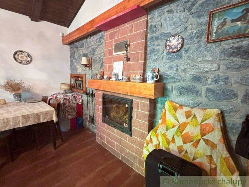 A fireplace with brick cladding in the interior of a family house. A table with a tablecloth and decorations.