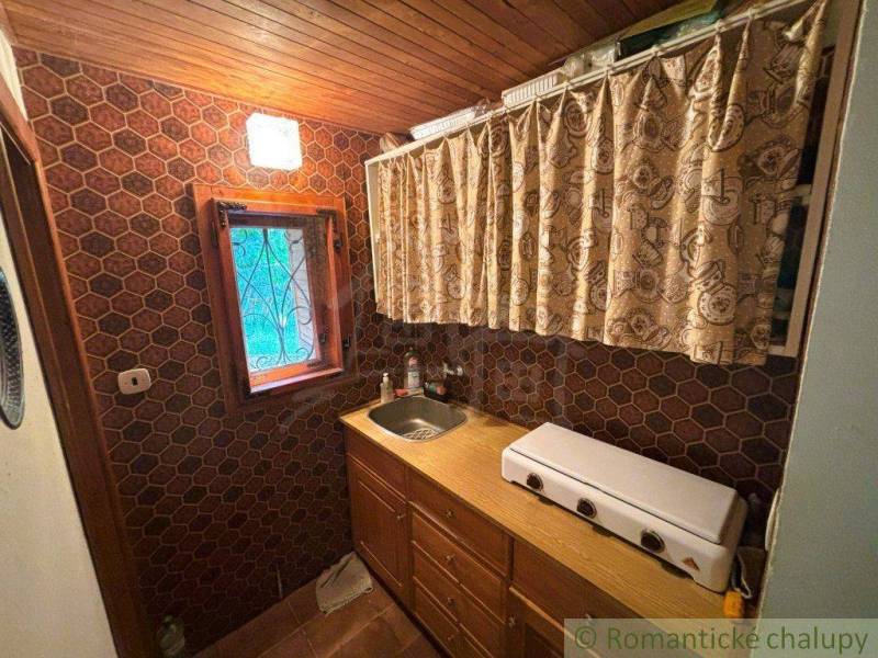A kitchen corner in a family house with an old two-burner stove and hexagonal tiles.