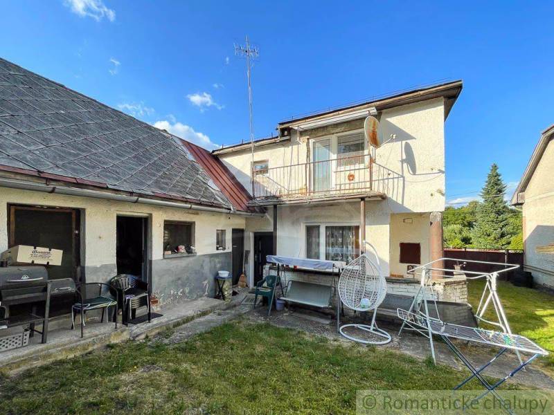Family house in Sielnica, garden with terrace, clothesline, hanging chair, blue sky.