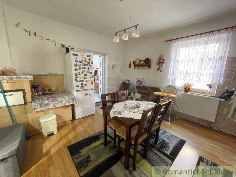 Dining area with a stove and refrigerator in a family house.