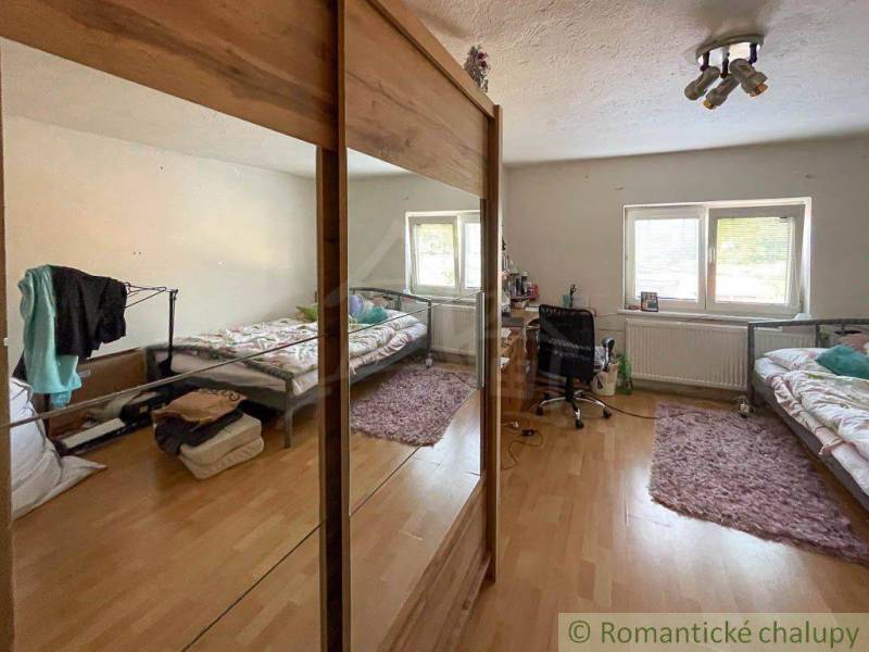 Bright room with space for sleeping and working in a family house.