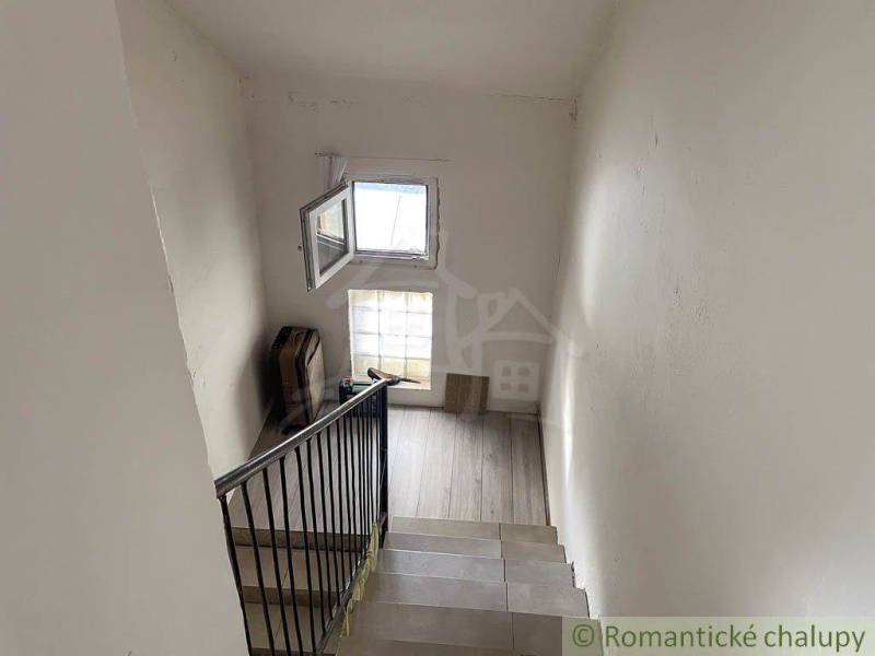 A staircase in a family house with a glazed window and matte walls.
