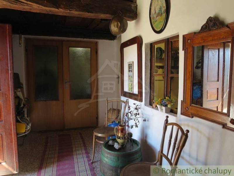 Traditional room with antique furniture, rustic atmosphere, decorations and mirrors, unique properties.