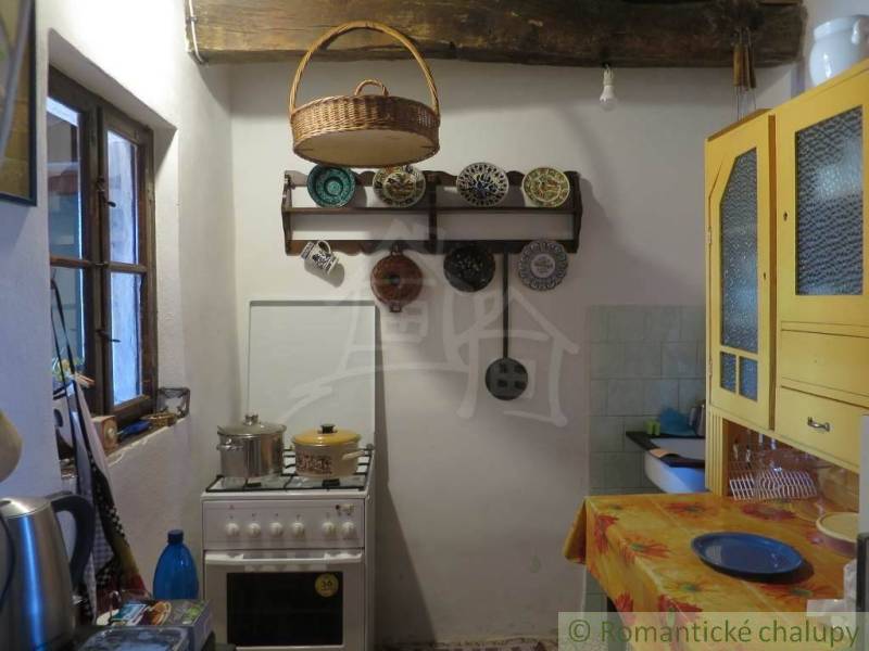A kitchen in a rustic style with traditional elements and unique properties.