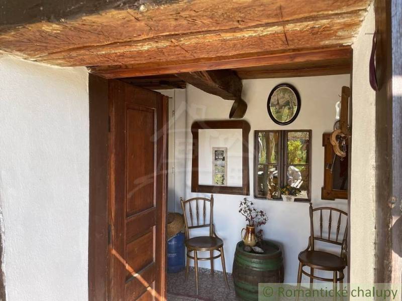 Entrance area of chalets, with wooden details and vintage decor, romantic cottages.