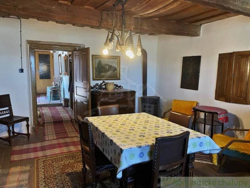 Rustic interior with a wooden ceiling, carpets, and antique furniture. Unique properties.