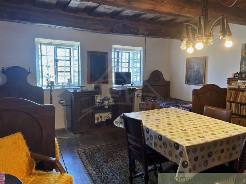 Traditional interior with real estate, wooden beams, and unique lighting, complemented by antique furniture.