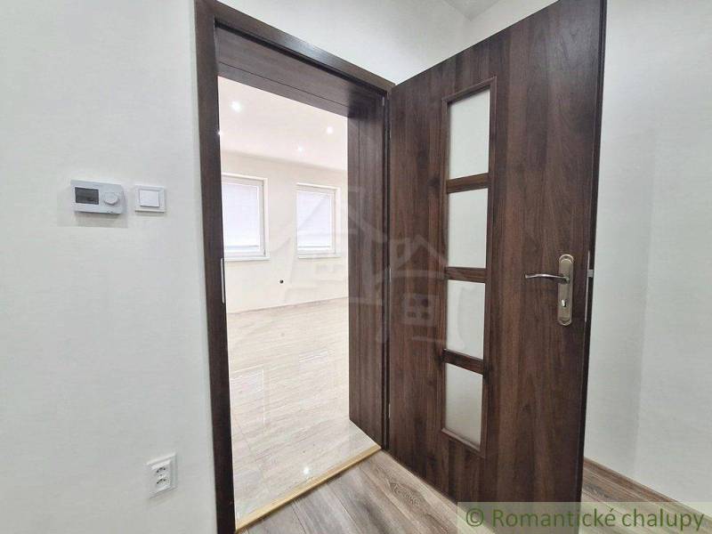 Interior of a family house with wooden doors and laminate flooring.